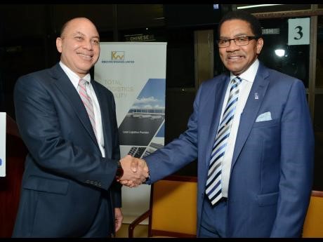 Kingston Wharves chairman Jeffrey Hall shakes hands with CEO Grantley Stephenson in this June 2015 Gleaner photo